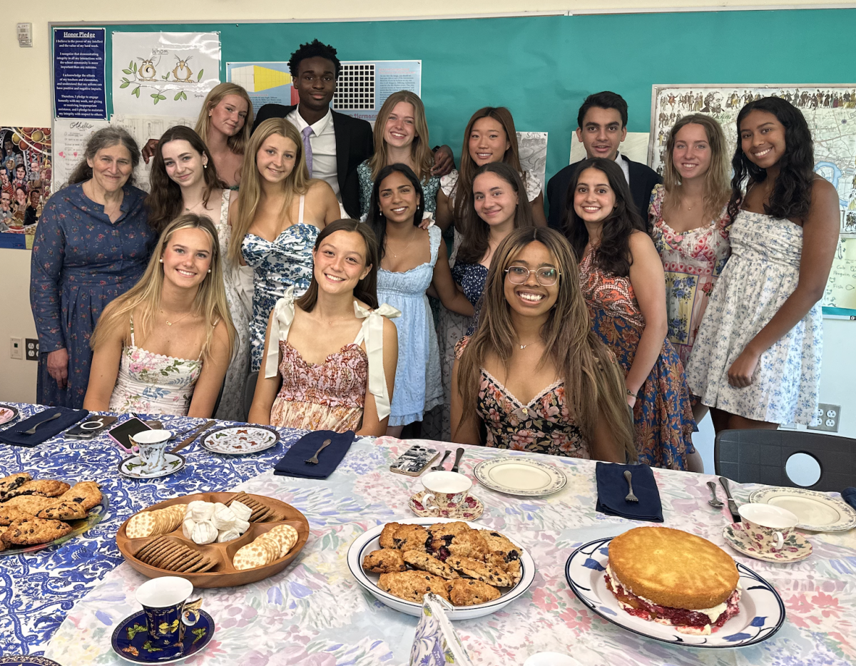 Ms. Nightingale stands with her Advanced British Women's Literature class on their last day of class tea party. 